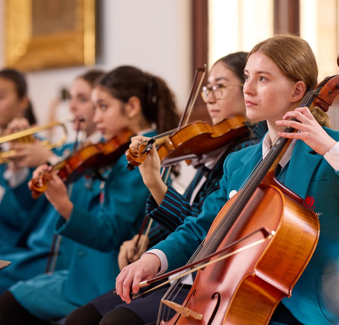 KRB students immersed in a cello and violin ensemble