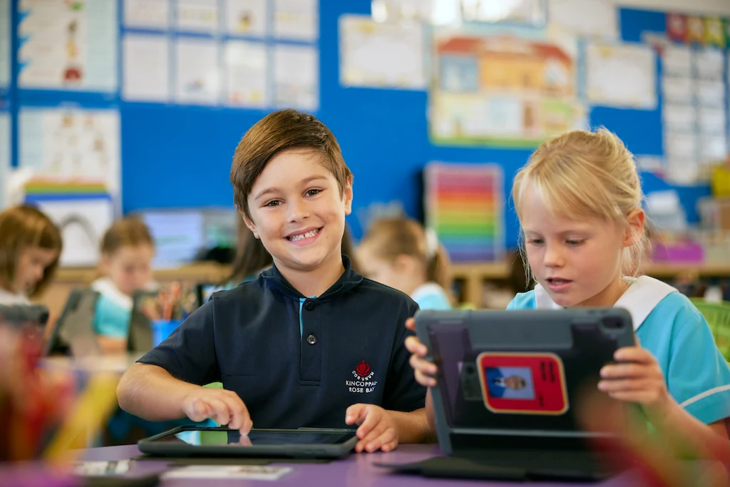 Two Junior School children using tablets in class